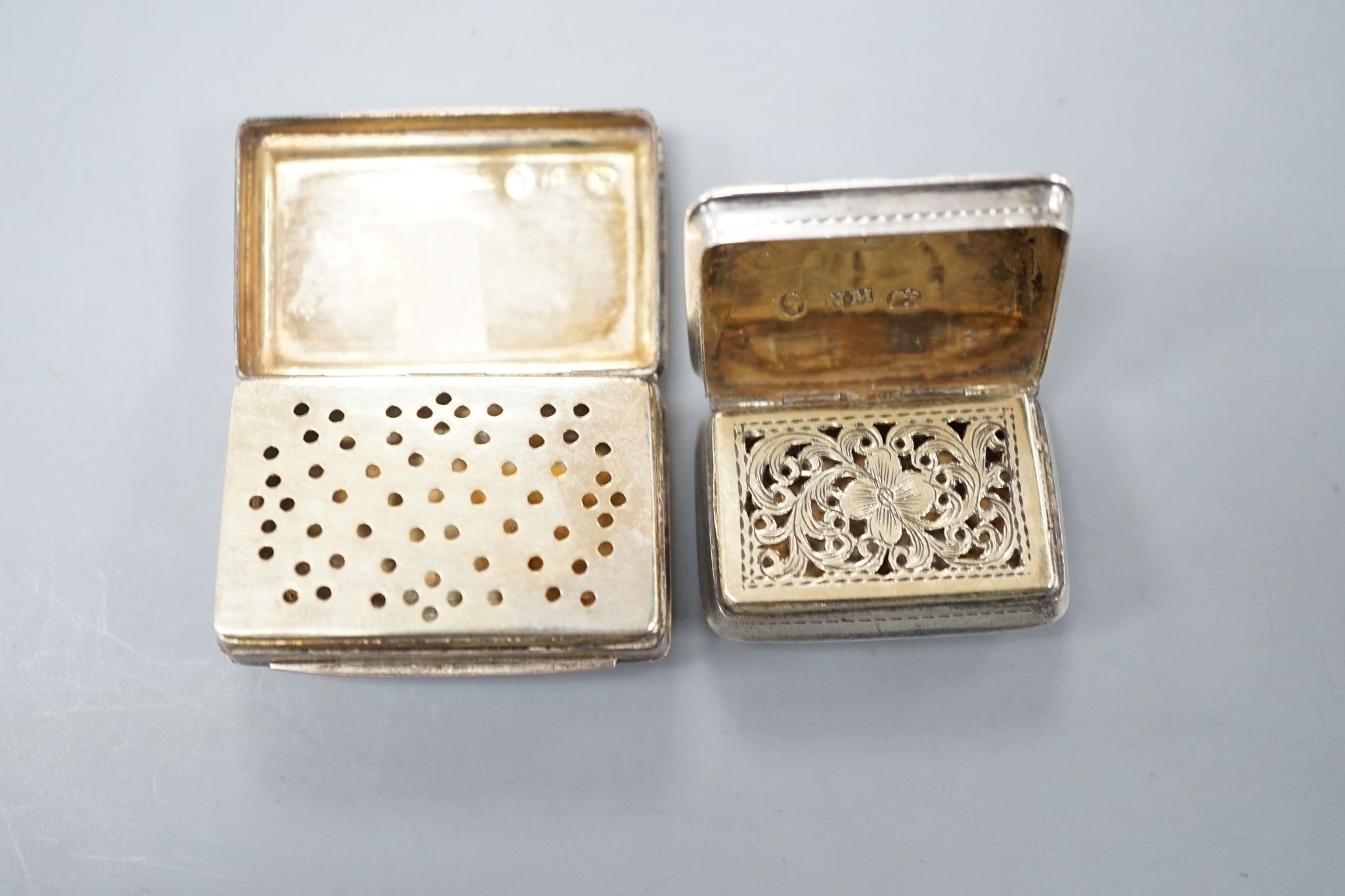 A George IV engraved silver rectangular vinaigrette, by Nathaniel Mills, Birmingham, 1827, engraved 'Celia', 31mm and a later vinaigrette, Birmingham, 1833.